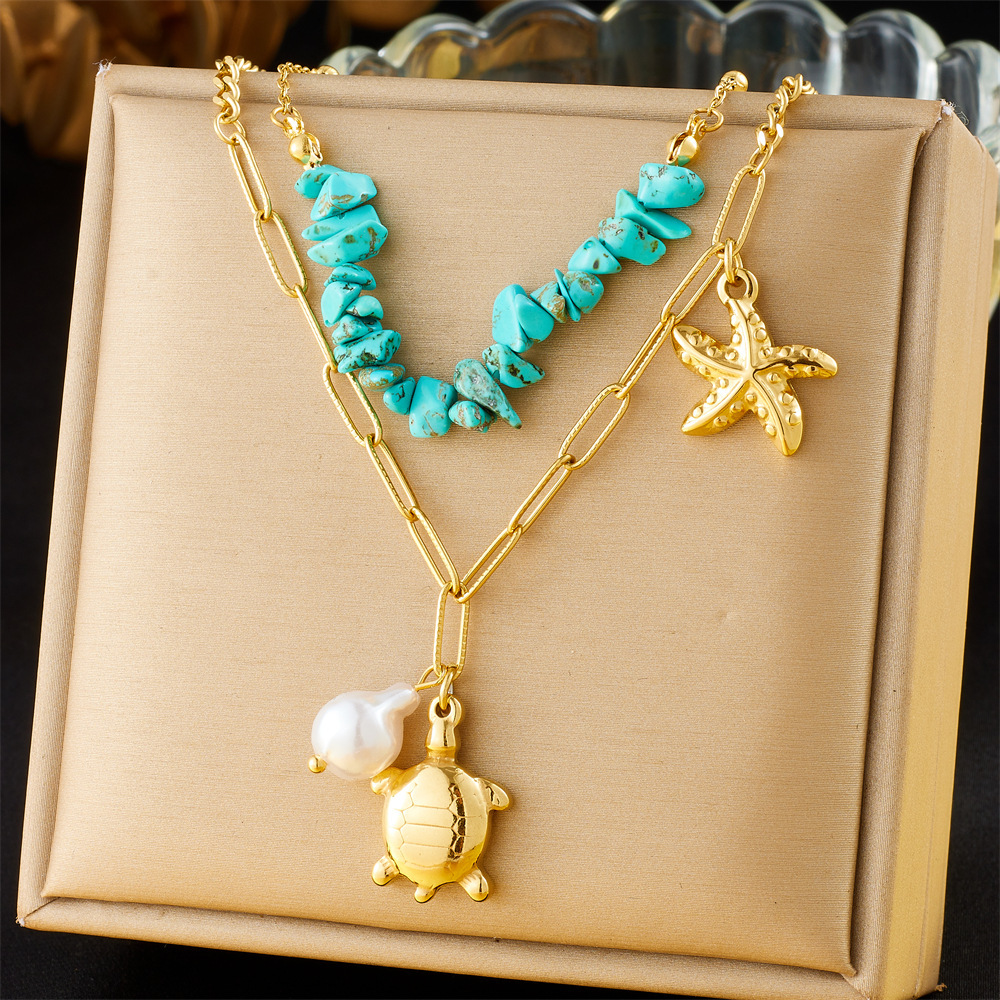 Fashionable and trendy double-layered stainless steel chain necklace featuring a turtle, starfish, blue pebble, and pearl design.