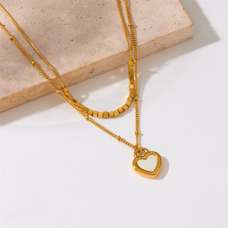 European and American style, simple and versatile, heart-shaped gold-plated titanium steel double-layer chain necklace with black and white heart pendant.