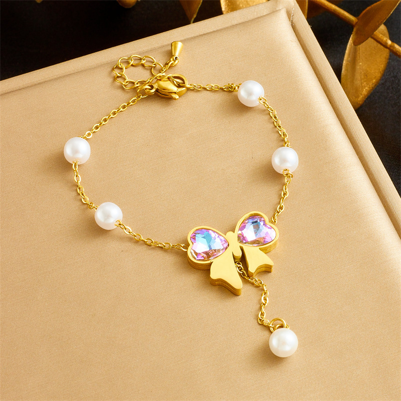 Cross-border fashion dazzling rhinestone bow gold-plated pearl chain stainless steel tassel pendant necklace and bracelet set