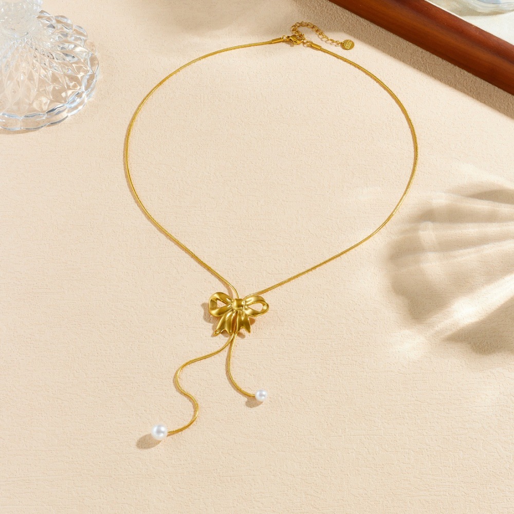 Korean style, trendy, niche design, gold-plated bow pearl pendant tassel stainless steel snake chain necklace