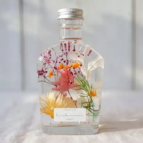 Amazing gifts real dried flowers floating herbarium oil bottle glass bottles for dried flowers decoration