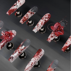 Close up of Phoenix Veil coffin nail highlighting molten metallic pigment, gold foil scatter, and glossy finish