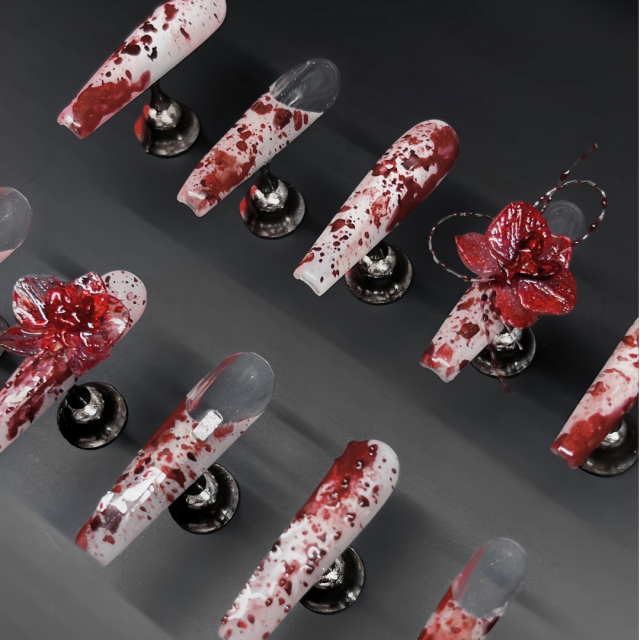 Close up of Phoenix Veil coffin nail highlighting molten metallic pigment, gold foil scatter, and glossy finish