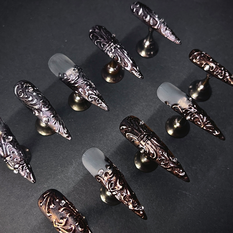 Baroque Night stiletto nails in natural daylight showing high-shine glossy radiance