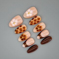 Close up of Auburn Petal almond nail highlighting glossy finish and warm red‑brown pigment