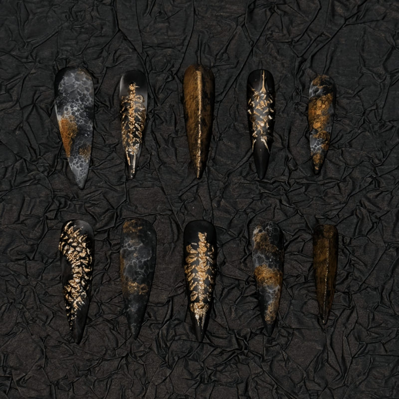 Aegis Valor long stiletto press-on nails with gunmetal chrome matte finish and antique gold rivets