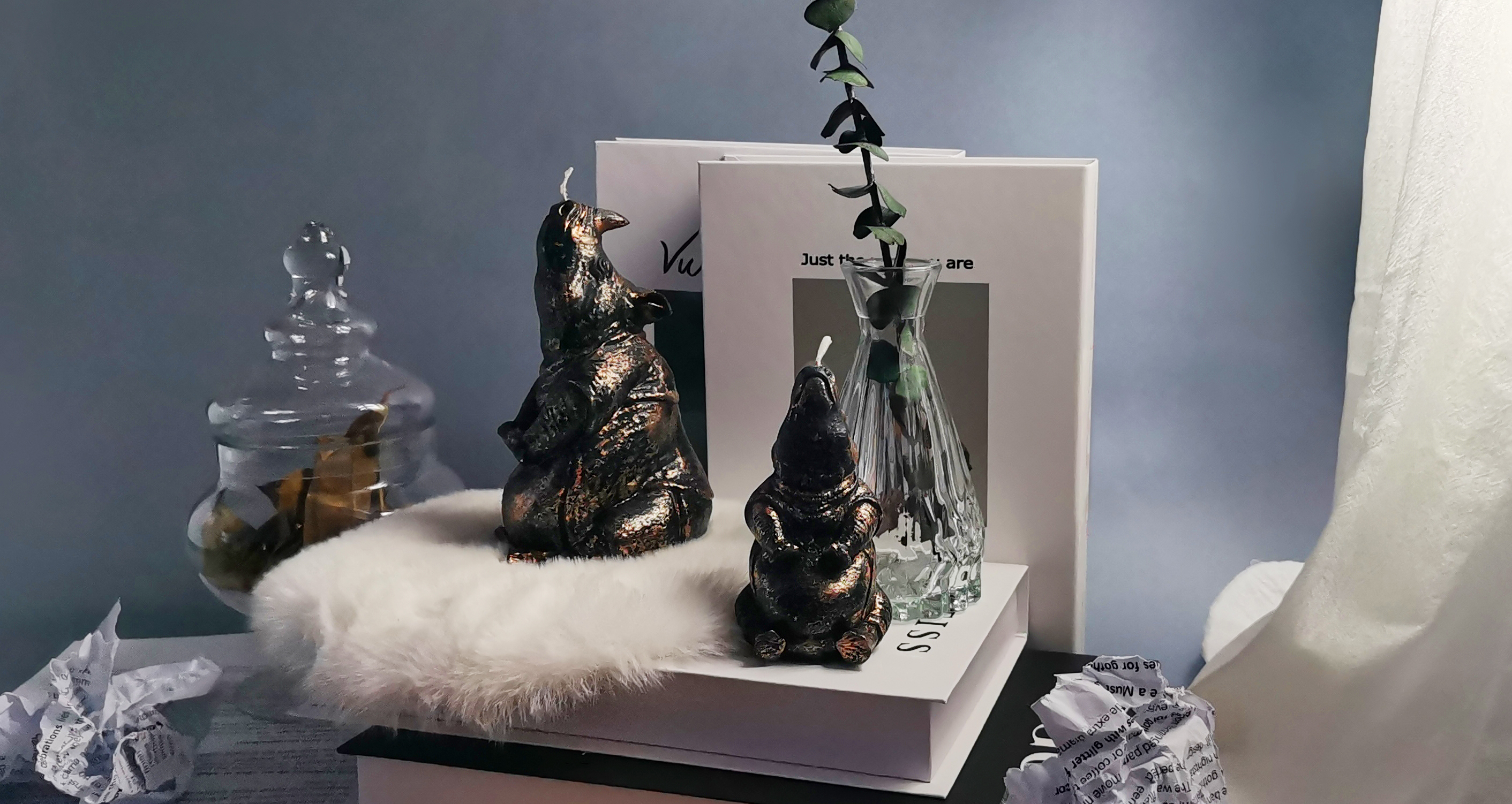 black rhino candles set by green leaves and books_horizontal