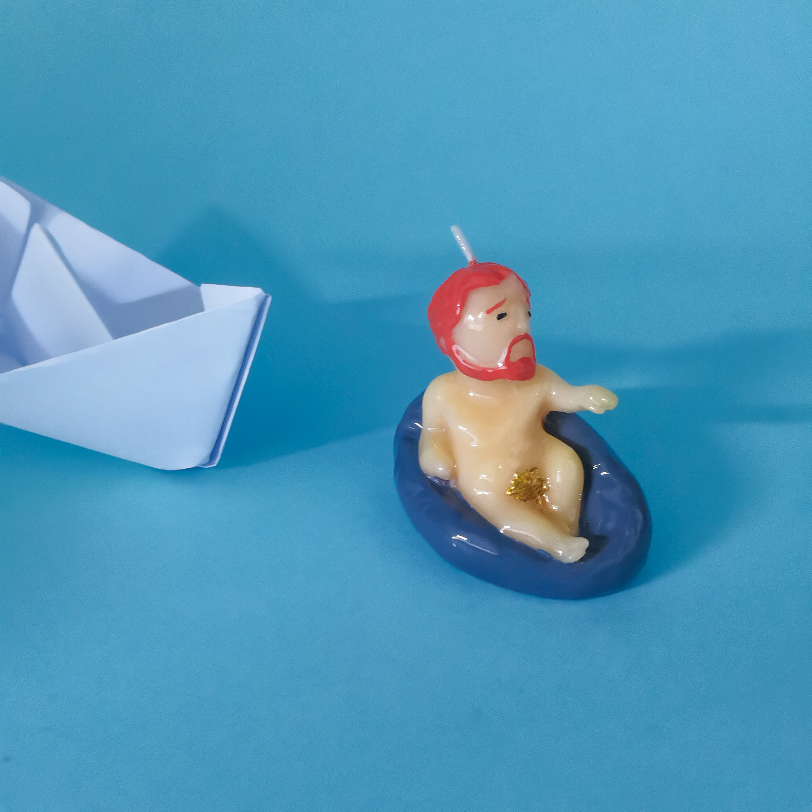 Bearded Jesus Candle on the water by a paper boat (4)