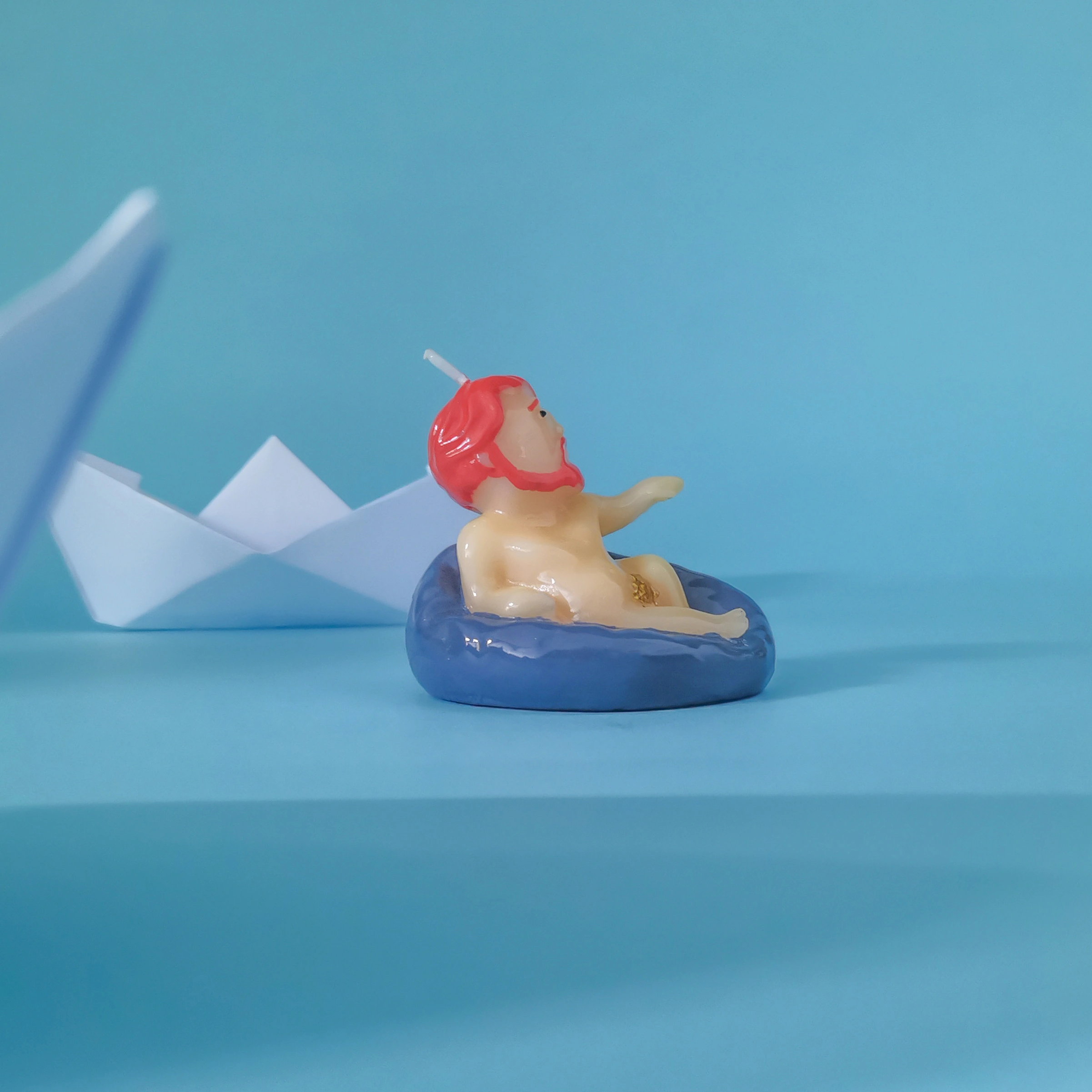 Bearded Jesus Candle on the water by a paper boat (3)
