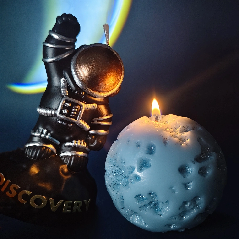 a black spacesuited astronaut figure candle d a sky blue m meteor ball candle_scene