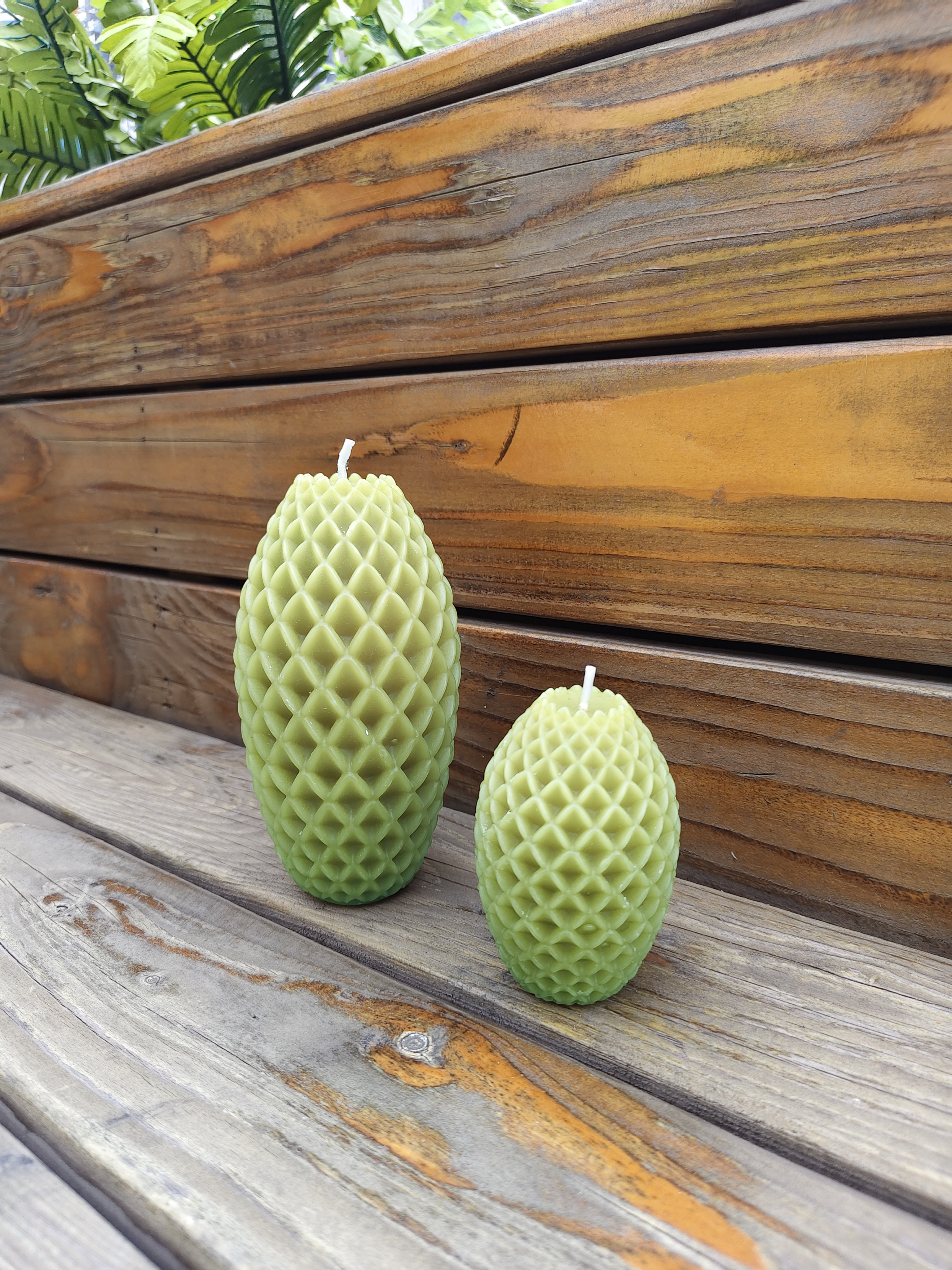 moss green pineapple candles on the bench
