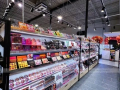 Black Framed Cosmetics Wall and Gondola Aisle Layout for Wig Shop