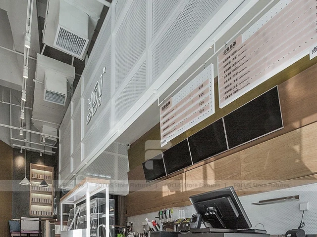 White Beverage Counter With Backlit Menu Wall