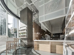 White Beverage Counter With Backlit Menu Wall