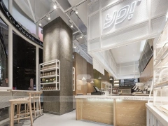 White Beverage Counter With Backlit Menu Wall