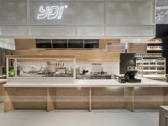 White Beverage Counter With Backlit Menu Wall