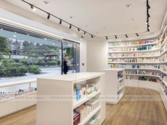 Curved White Pharmacy Counter with Wood Wall Shelving