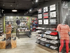 Dark Sneaker Wall Shelving and Apparel Display