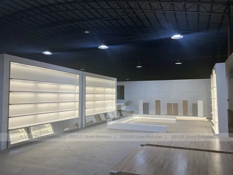 Illuminated White Wall Shelving and Checkout Display