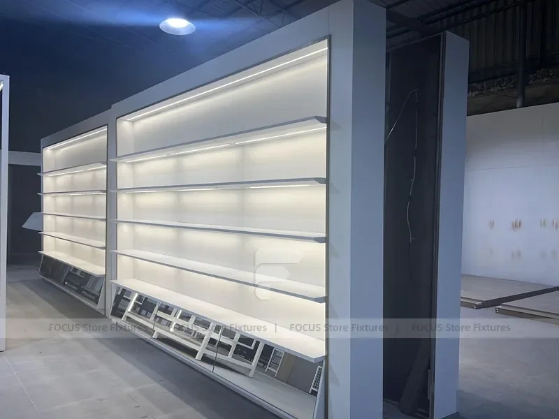 Illuminated White Wall Shelving and Checkout Display