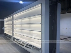 Illuminated White Wall Shelving and Checkout Display