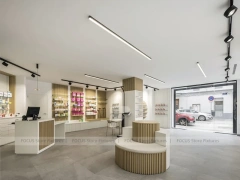 Minimal White Pharmacy Interior with Round Counter