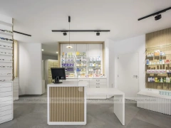 Minimal White Pharmacy Interior with Round Counter