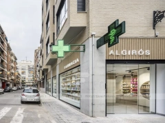 Minimal White Pharmacy Interior with Round Counter