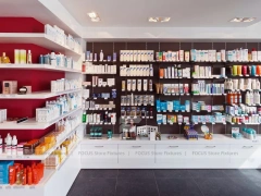 Minimal White Pharmacy Shelving with Red Accent Gondola