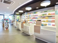 Minimal White Pharmacy Shelving with Red Accent Gondola