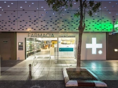 Night Facade Pharmacy Storefront with Wood Counter Interior