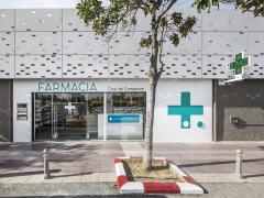Night Facade Pharmacy Storefront with Wood Counter Interior
