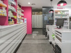 Pink Accent Pharmacy Checkout Counters and Wall Shelving