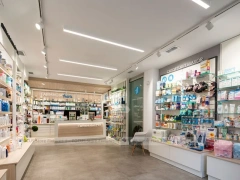White Linear Pharmacy Aisle Shelving and Back Counter