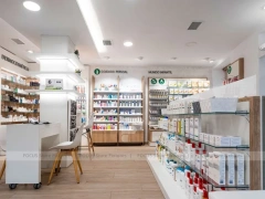 White Linear Pharmacy Aisle Shelving and Back Counter