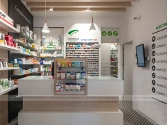 White Linear Pharmacy Aisle Shelving and Back Counter