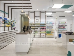 White Pharmacy Checkout Counter with Black Signage Wall
