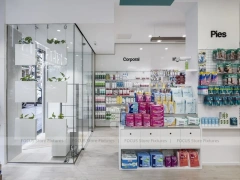White Pharmacy Checkout Counter with Black Signage Wall