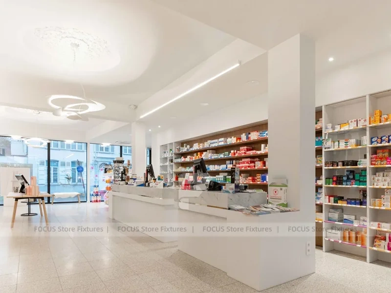 White Pharmacy Reception Counter with Dark Wall Shelves