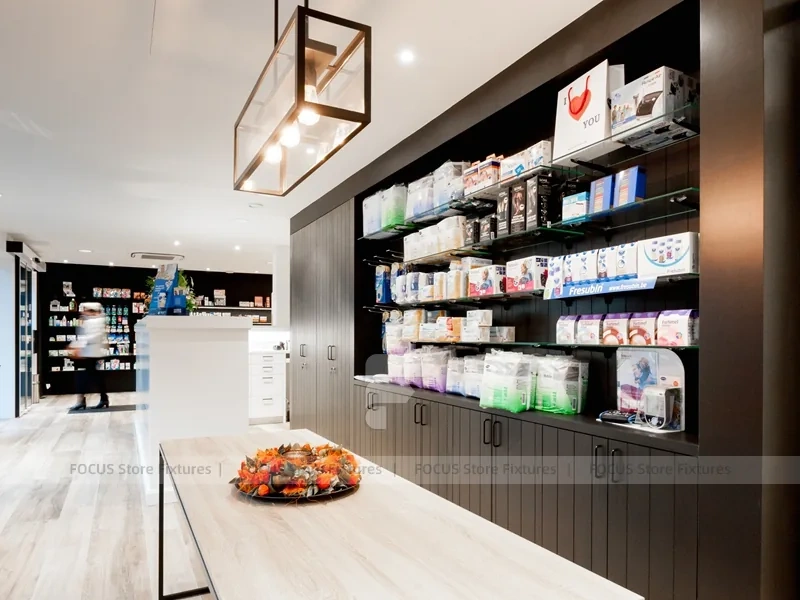 White Pharmacy Reception Counter with Dark Wall Shelves