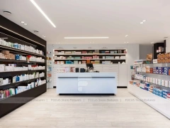 White Pharmacy Reception Counter with Dark Wall Shelves