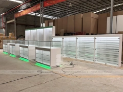 Long White Mobile Phone Counter With Green Lighting