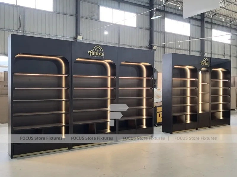 Dark Perfume Wall Shelving With Gold Arch Frames