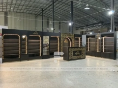 Dark Perfume Wall Shelving With Gold Arch Frames