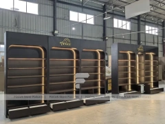 Dark Perfume Wall Shelving With Gold Arch Frames