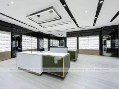 Glossy White Eyewear Boutique Interior with Gold Accent Counter