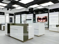 Glossy White Eyewear Boutique Interior with Gold Accent Counter