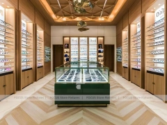 Gold Accent Optical Gallery Interior with Emerald Demo Island