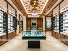 Gold Accent Optical Gallery Interior with Emerald Demo Island