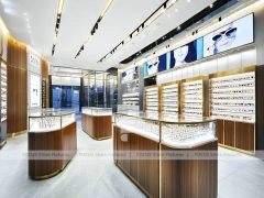 Linear Walnut Eyewear Retail Gallery with Multi-Island Merchandising